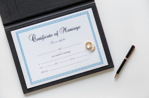 : Bride signing marriage certificate at wedding ceremony, illustrating how to correct marriage certificate errors