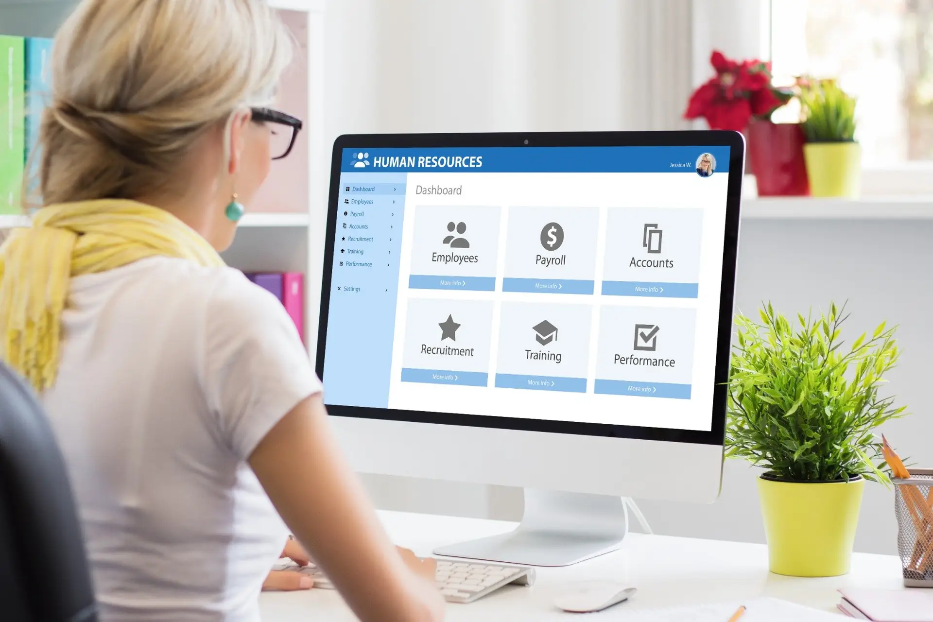 HR manager updating payroll and employee records on a computer after a legal name change.